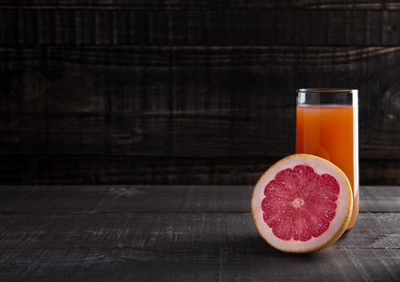 Glass of healthy grapefruit  juice with fruit on wooden backgroundの写真素材