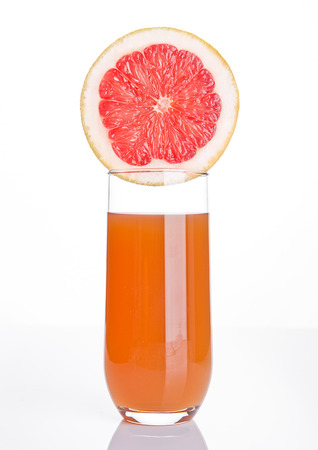 Glass of healthy grapefruit  juice with fruit on wooden backgroundの写真素材