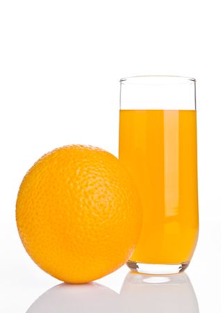 Glass of healthy orange juice with fruit on white backgroundの写真素材