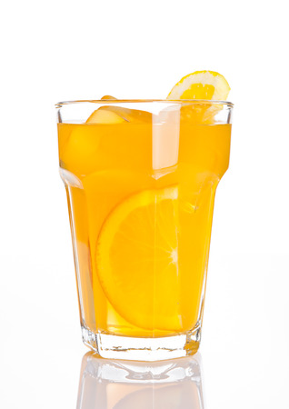 Glass of healthy orange juice with ice cubes on white backgroundの写真素材