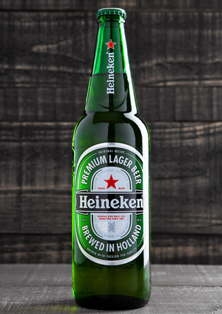 LONDON,UK -OCTOBER 17, 2016: Bottle of Heineken Lager Beer on grunge wooden background. Heineken is the flagship product of Heineken Internationalのeditorial素材