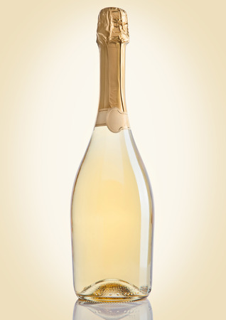 Bottle of champagne golden yellow color on golden backgroundの写真素材