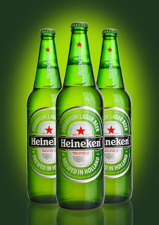 LONDON,UK -OCTOBER 23, 2016: Bottles of Heineken Lager Beer on green background. Heineken is the flagship product of Heineken Internationalのeditorial素材