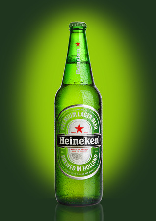 LONDON,UK -OCTOBER 23, 2016: Bottle of Heineken Lager Beer on green background. Heineken is the flagship product of Heineken Internationalのeditorial素材