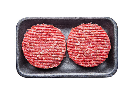 Tray with raw beed burgers isolated on whiteの写真素材