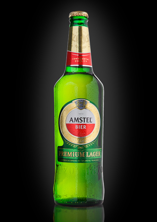LONDON, UNITED KINGDOM - NOVEMBER 01, 2016: Cold bottle of Amstel Premium Lager on black background.Amstel is an internationally known brand of beer produced by Heineken International in Zoeterwoude, Netherlands.のeditorial素材