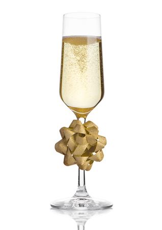 Glass of champagne with christmas decoration gift on white isolatedの写真素材