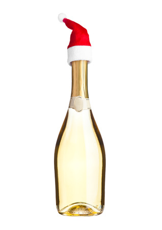 Bottle of yellow champagne with santa hat on white backgroundの写真素材