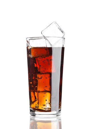 Glass of cola soda drink cold with ice cubes on white background with reflectionの写真素材