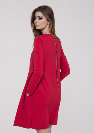 Beautiful young girl in red dress fashion on grey backgroundの写真素材