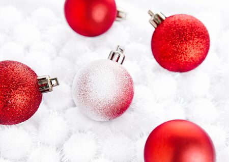 Red christmas ball on snow balls on white backgroundの写真素材
