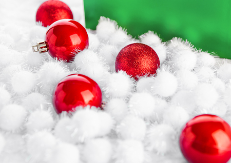 Green gift box for christmas with toys and snow on white backgroundの写真素材