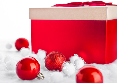 Red gift box for christmas with toys and snow on white backgroundの写真素材