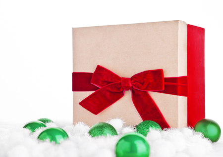 Red gift box for christmas with toys and snow on white backgroundの写真素材