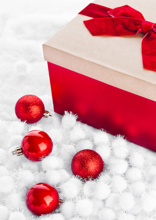Red gift box for christmas with toys and snow on white backgroundの写真素材