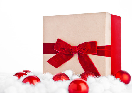 Red gift box for christmas with toys and snow on white backgroundの写真素材
