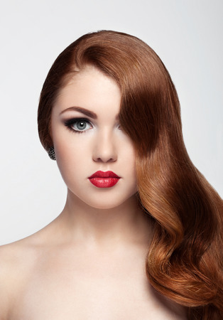 Ginger red long hair.Fashion portrait red lips on white backgroundの写真素材