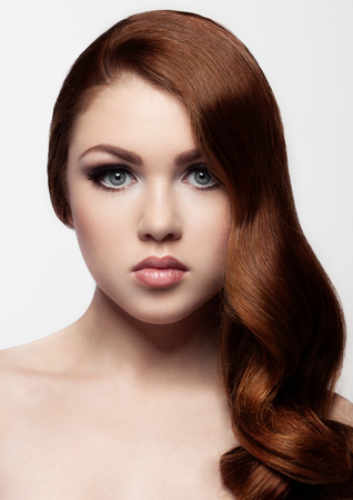 Ginger red long hair.Fashion girl portrait on white backgroundの写真素材