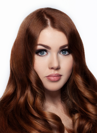 Ginger red long hair.Fashion girl portrait on white backgroundの写真素材