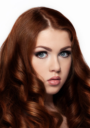 Ginger red long hair.Fashion girl portrait on white backgroundの写真素材