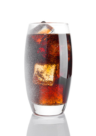 Glass of cold cola soda drink with snow and ice on white backgroundの写真素材