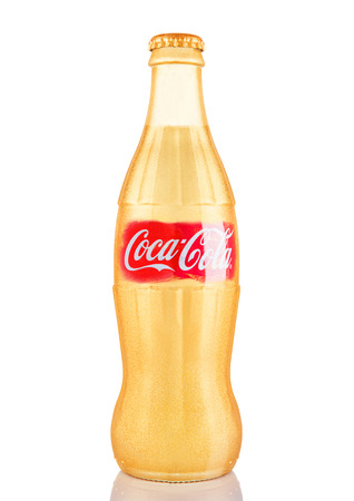 LONDON, UK - NOVEMBER 07, 2016: Golden classic bottle of Coca-cola with logo on white backgroundのeditorial素材