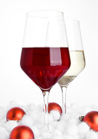 Glasses of red and white wine on white backgroundの写真素材