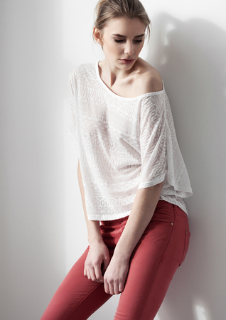 Beautiful young fashion girl model posing on white backgroundの写真素材