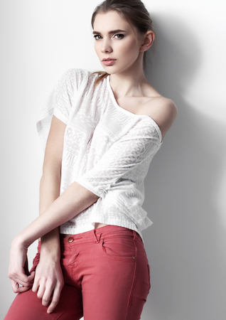 Beautiful young fashion girl model posing on white backgroundの写真素材