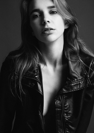 Portrait of beautiful woman girl leather jacket black and whiteの写真素材
