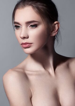 Beautiful woman portrait with natural makeup on greyの写真素材