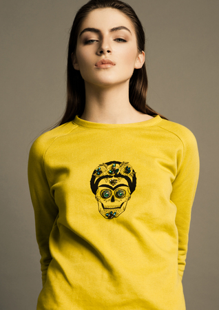 Beautiful fashion model wearing yellow jumper skull in studioの写真素材