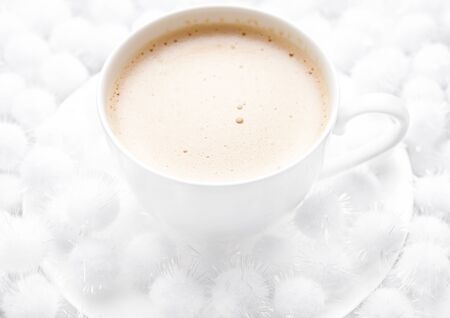 Cup of cappuccino coffee on snow backgroundsの写真素材