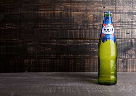 LONDON, UK- NOVEMBER 15 ,2016. Cold bottle of Kronenbourg 1664 beer on wooden background. A 5.5% pale lager is the main brand of Kronenbourg Brewery owned by the Carlsberg Groupのeditorial素材