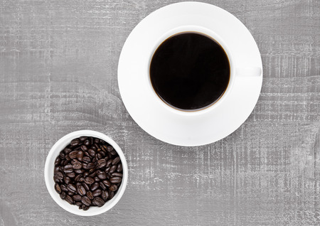Cup of black  coffee for breakfast with beans on coffee beans backgroundの写真素材