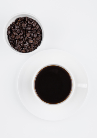 Cup of black  coffee for breakfast with beans on white backgroundの写真素材
