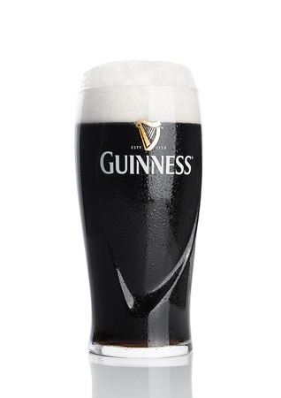 LONDON, UK - NOVEMBER 29, 2016: Glass of Guinness original beer on white background. Guinness beer has been produced since 1759 in Dublin, Ireland.のeditorial素材