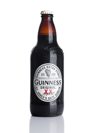 LONDON, UK - NOVEMBER 29, 2016: Guinness extra stout beer  bottle on white background. Guinness beer has been produced since 1759 in Dublin, Ireland.のeditorial素材