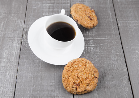 Cup of fresh coffee with cookies for breakfast on wooden boardの写真素材