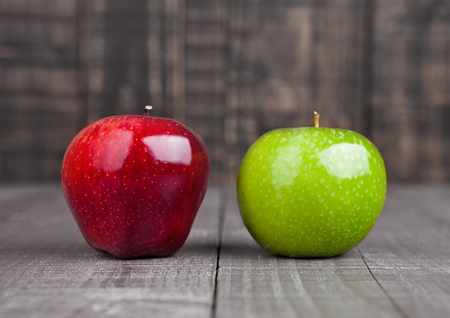 Red and green apples on wooden backgroundの写真素材