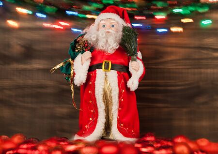 Santa toy decoration on moving bokeh wooden backgroundの写真素材