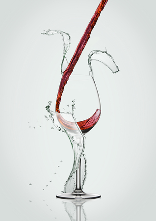 Pouring red wine to glass with water splashes on white backgroundの写真素材
