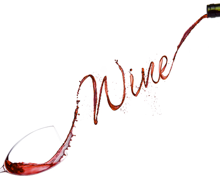 Pouring red wine from bottle to the glass  on white backgroundの写真素材