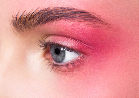 Beauty makeup pink eyes close up retouched skin with blue eyesの写真素材
