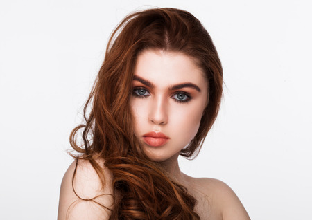 Ginger red long hair.Fashion beauty portrait red lips on white backgroundの写真素材