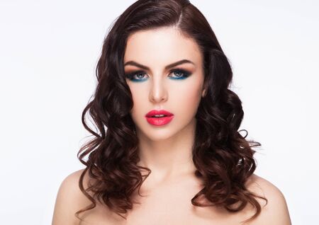 Beauty blue eyes red lips makeup fashion model with curly hair on white backgroundの写真素材