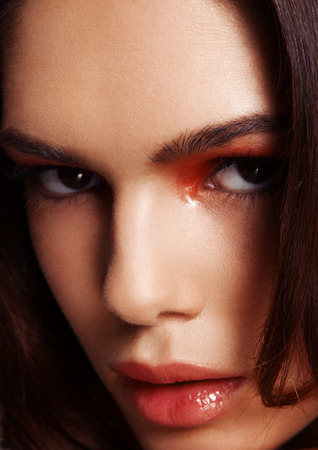 Beauty red eyes and lips makeup fashion model on grey backgroundの写真素材