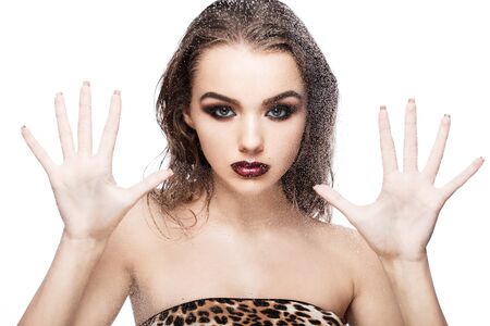 Beauty woman girl natural makeup looking through wet glass on white backgroundの写真素材