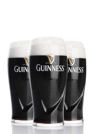 LONDON, UK - FEBRUARY 26, 2017: Glasses of Guinness original beer on white background. Guinness beer has been produced since 1759 in Dublin, Ireland.のeditorial素材