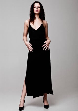 Sexy beautiful fashion model wearing black dress beautiful body on grey backgroundの写真素材